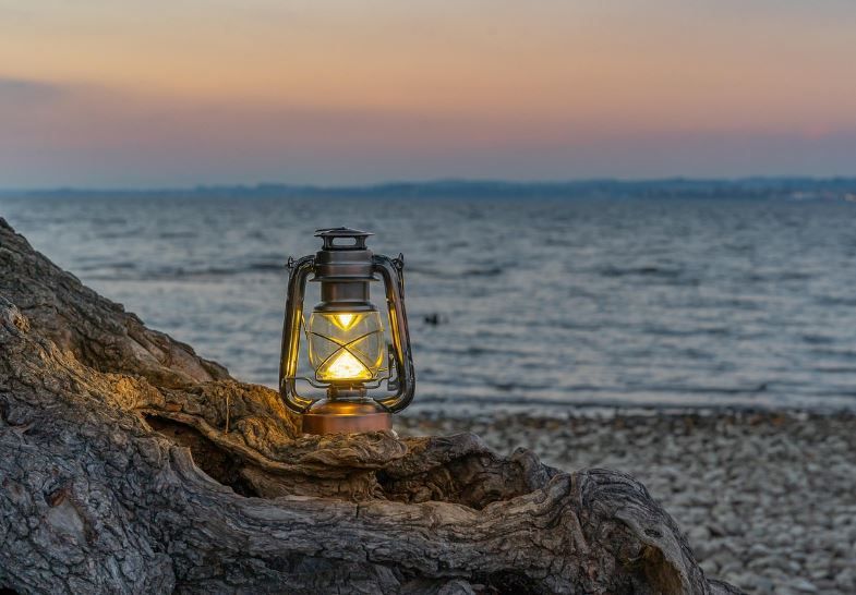 Quiet beach lantern scene highlights why cremation services Aledo, TX matter to families