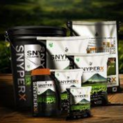 Assorted SNYPERX supplement containers on a wooden surface, including a black bucket, pouches, and a bottle.