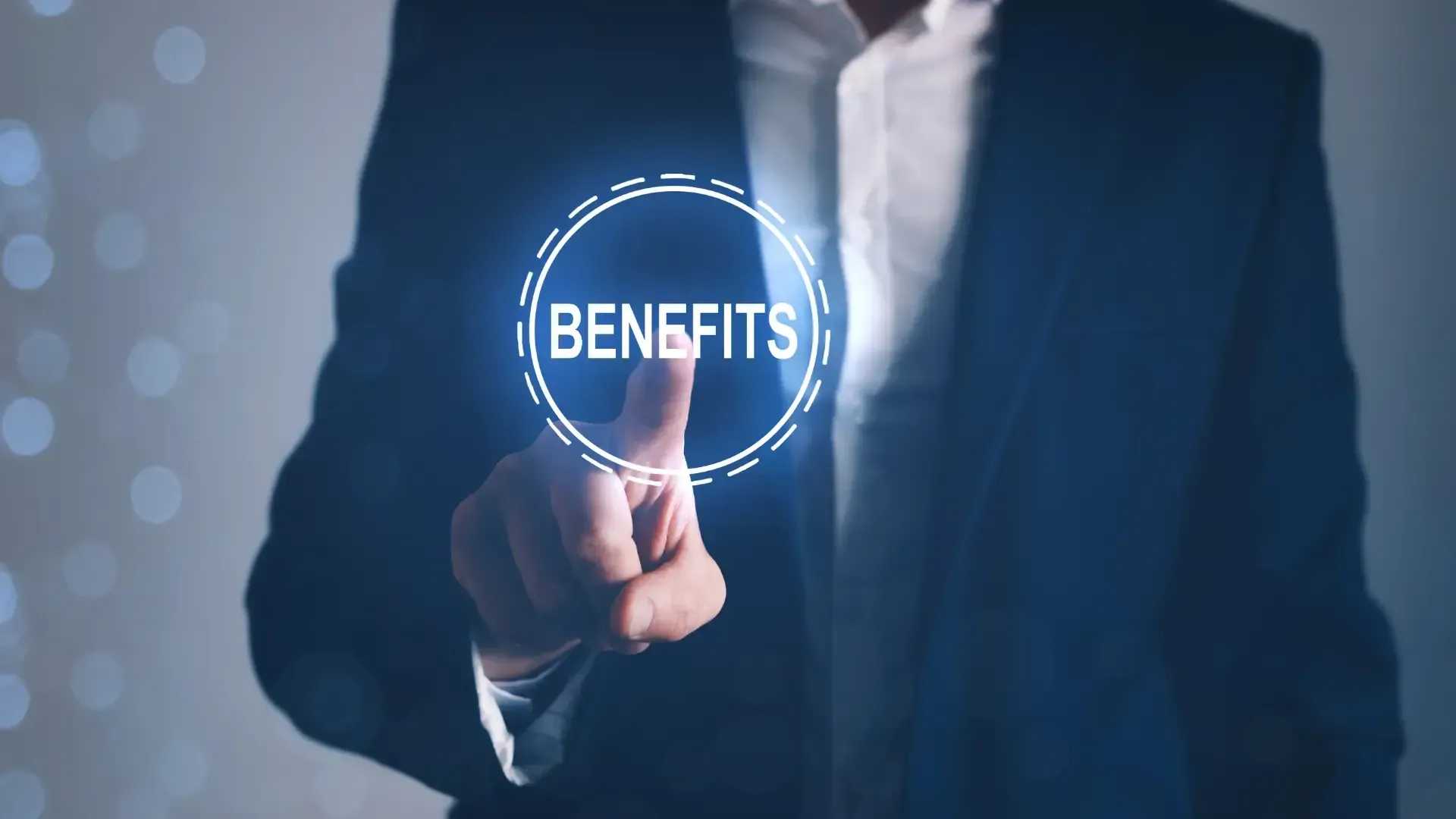 A man in a suit is pressing a button that says benefits.