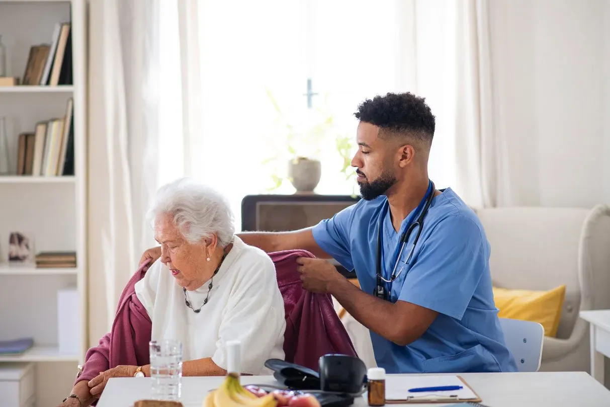 caregiver visiting senior woman