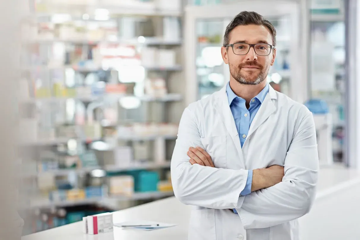 pharmacist standing with his arms crossed