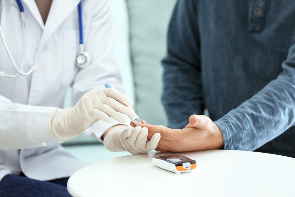 doctor taking sample of diabetic patient