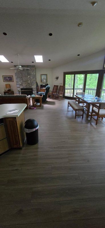 Spacious dining hall with tables, chairs, and large windows letting in natural light.