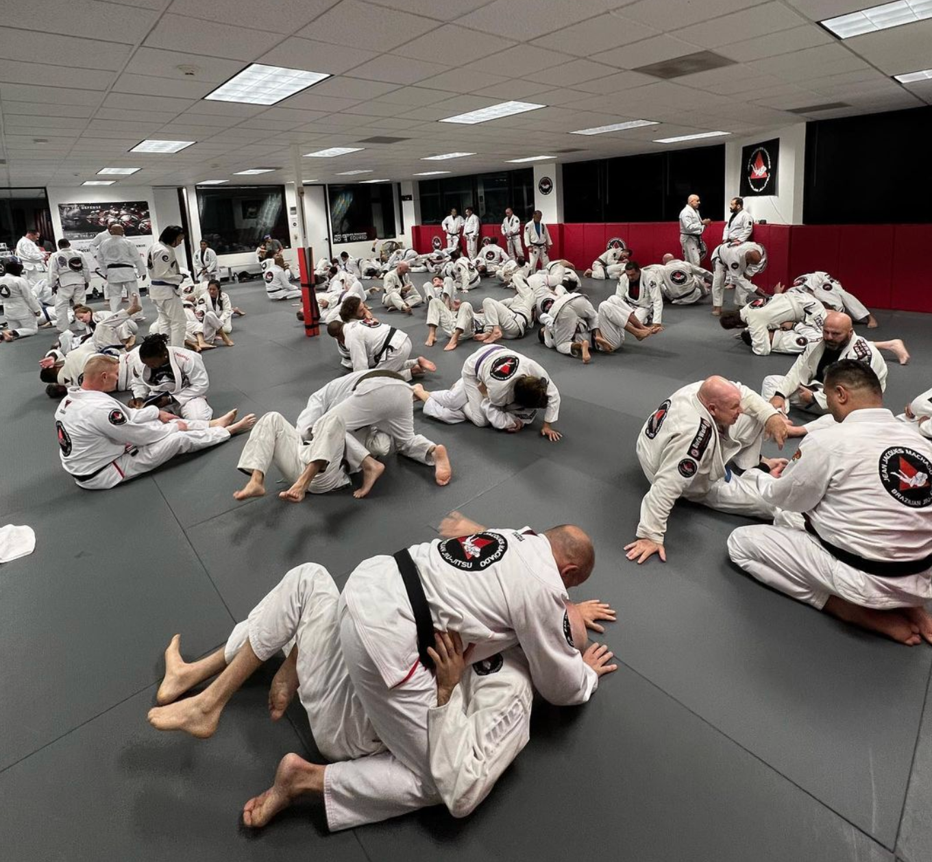Adult students training Brazilian Jiu-Jitsu at Jean Jacques Machado Jiu-Jitsu Fresno in Fresno, CA for confidence.