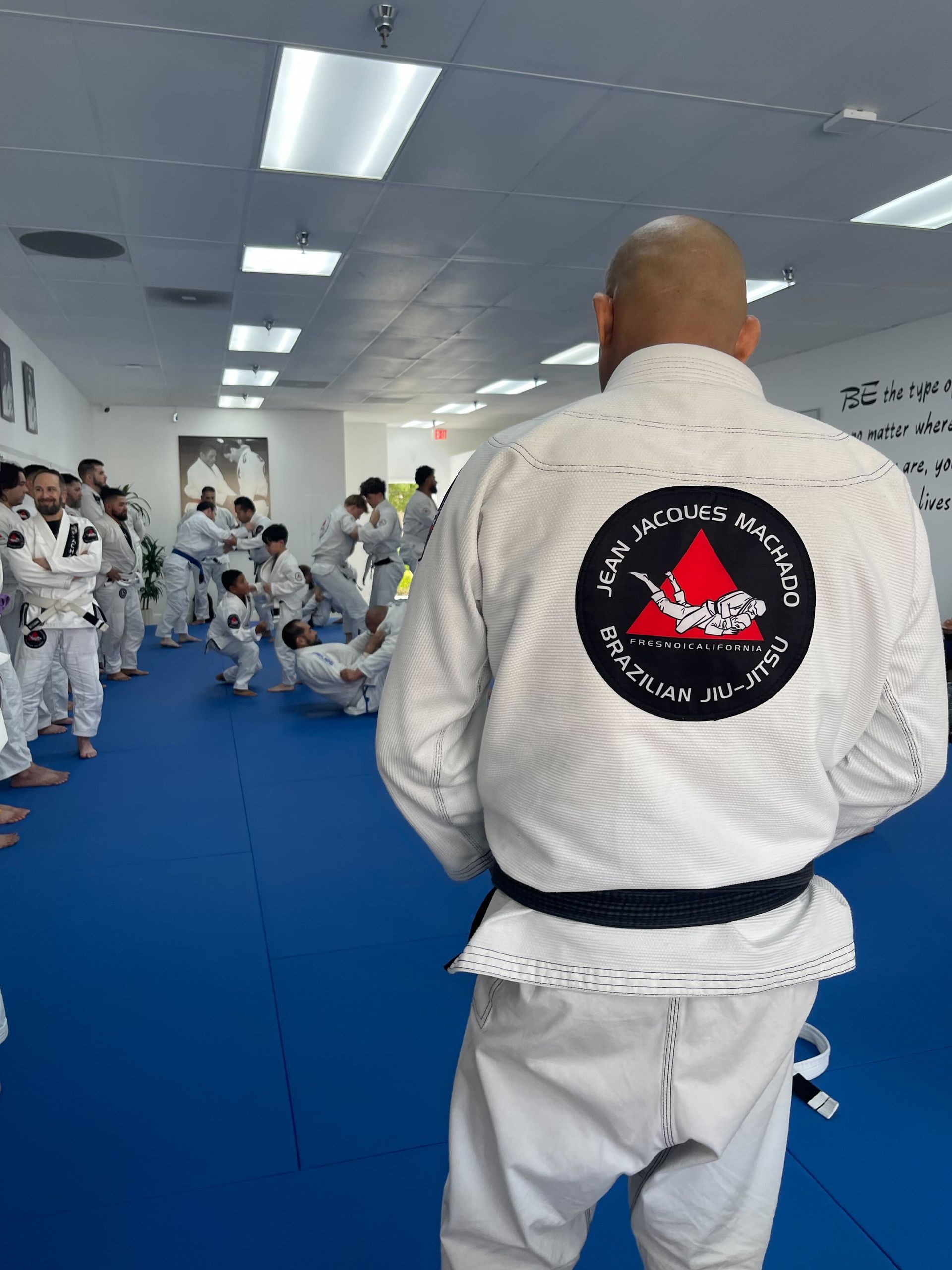 Adults practicing Brazilian Jiu-Jitsu drills at Jean Jacques Machado Jiu-Jitsu Fresno in Fresno, CA for stress relief