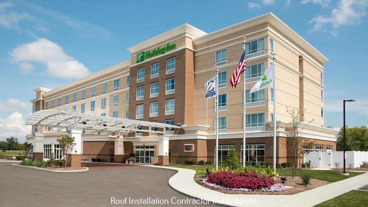 A multi-story Holiday Inn hotel building featuring a brick and tan facade, a prominent entryway canopy, and three flags.