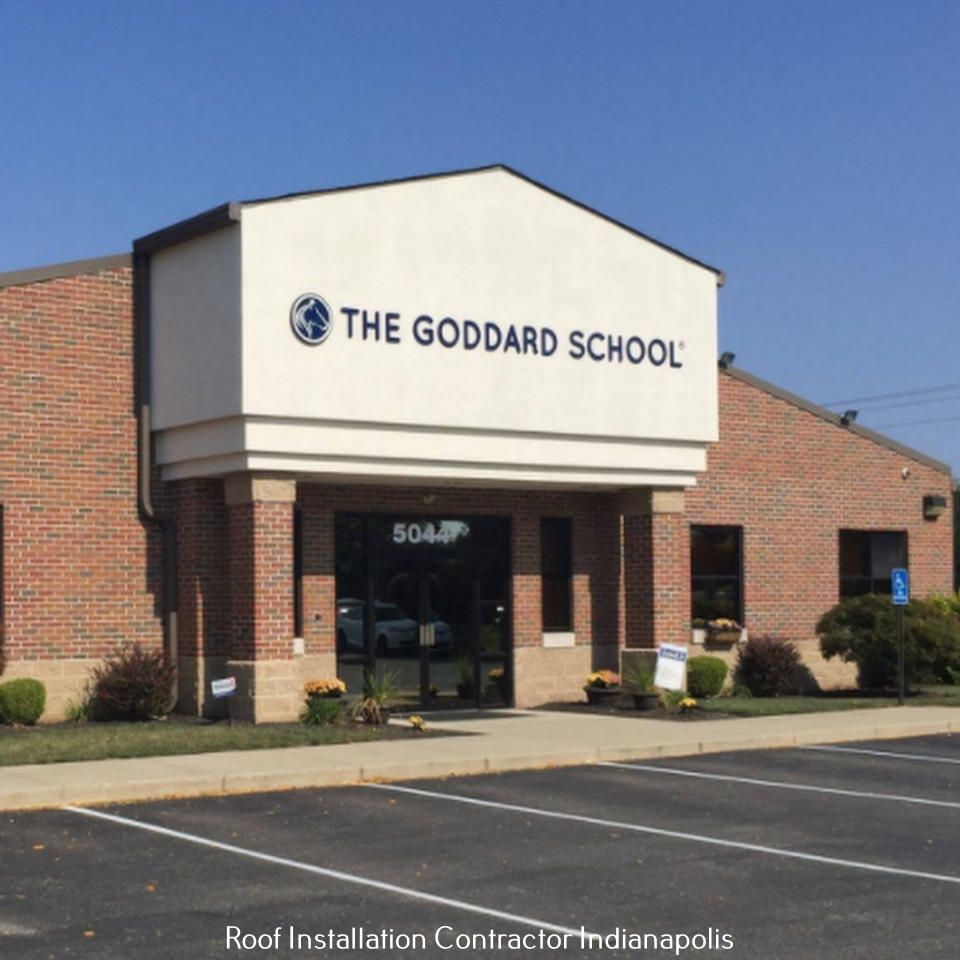 The Goddard School building with a brick exterior, signage above the entrance, and a parking lot on a sunny day.