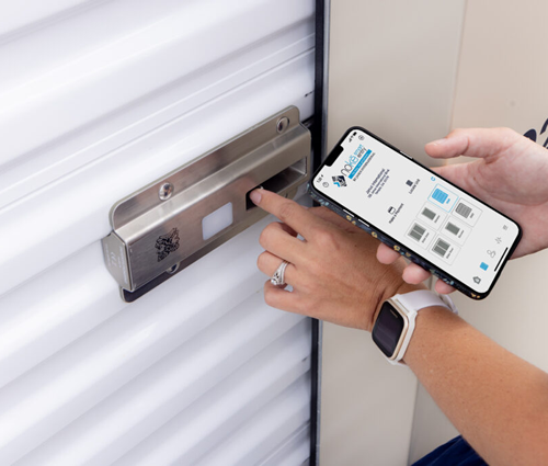 image of someone holding cellphone to smart lock opening unit with cellphone at anchored away storage