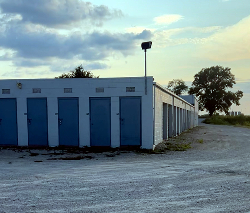 A row of blue doors on a white building