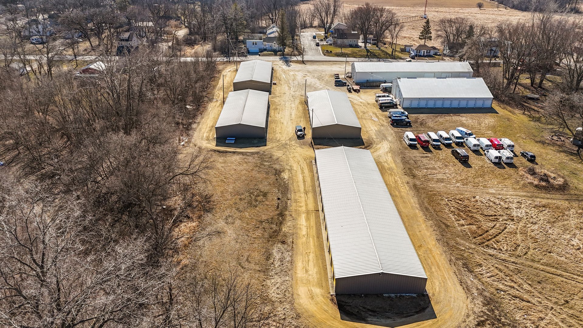 An aerial view of a row of buildings in a field.