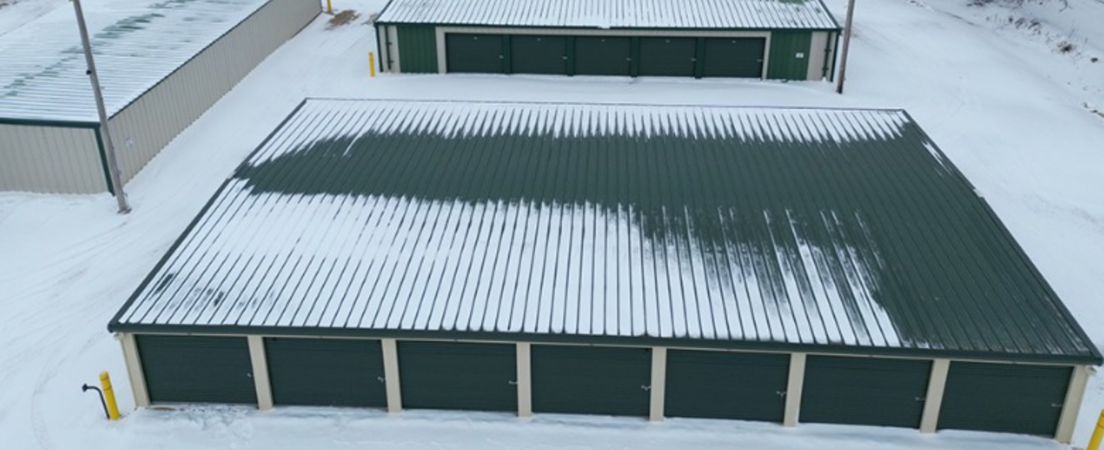 An aerial view of a storage facility covered in snow.