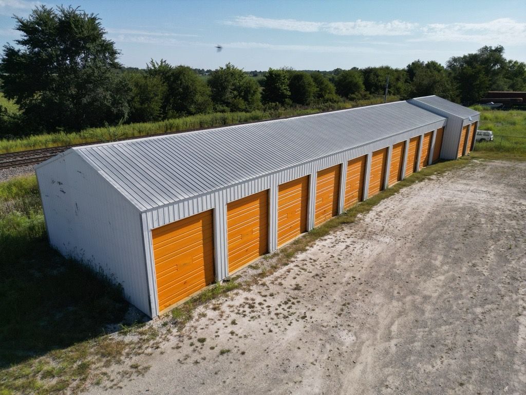 An aerial view of a large white building with lots of doors