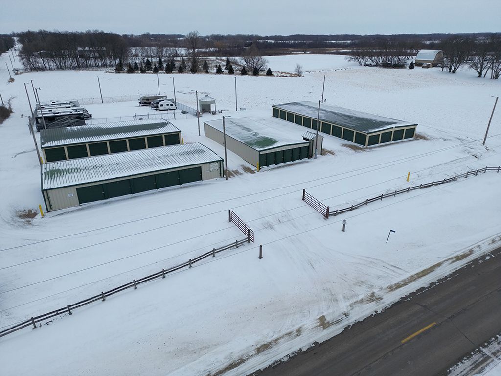 An aerial view of a storage facility covered in snow.