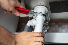 Person is Fixing a Sink Pipe with a Pair of Pliers — Scotts Valley, CA — George Allen & Sons Inc. Plumbing Person is Fixing a Sink Pipe with a Pair of Pliers — Scotts Valley, CA — George Allen & Sons Inc. Plumbing