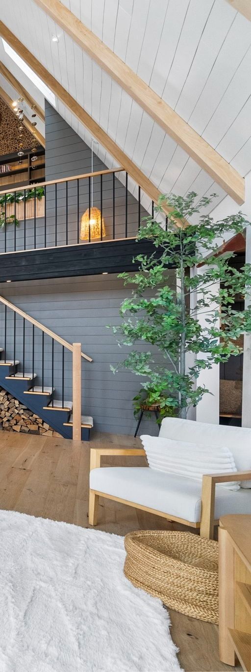 Skyline of modern buildings along a body of water under a blue sky.