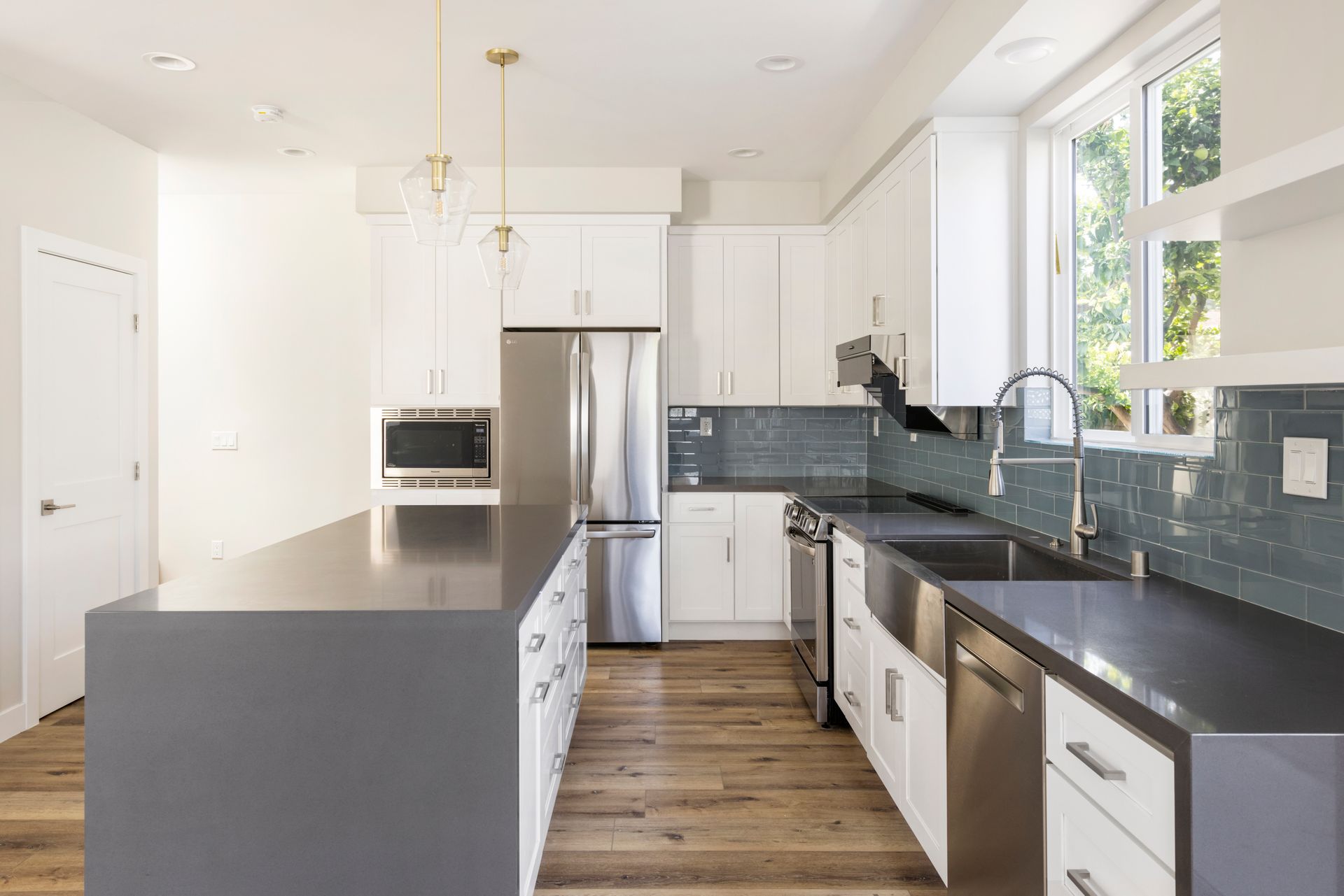 The full kitchen accessory dwelling unit (ADU) featuring plenty of space, an island, and modern all-electric appliances. 