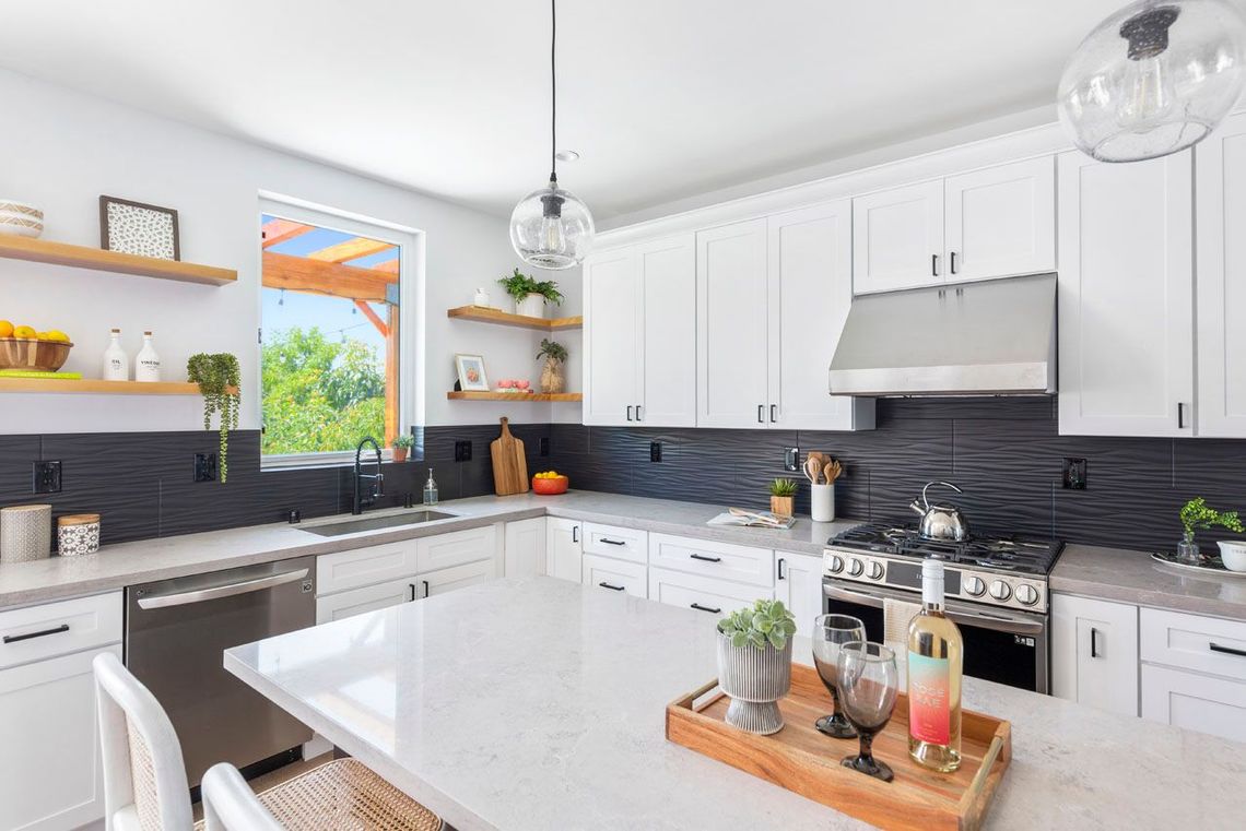 The full kitchen inside an accessory dwelling unit (ADU) backyard home, featuring modern all-electric appliances. 