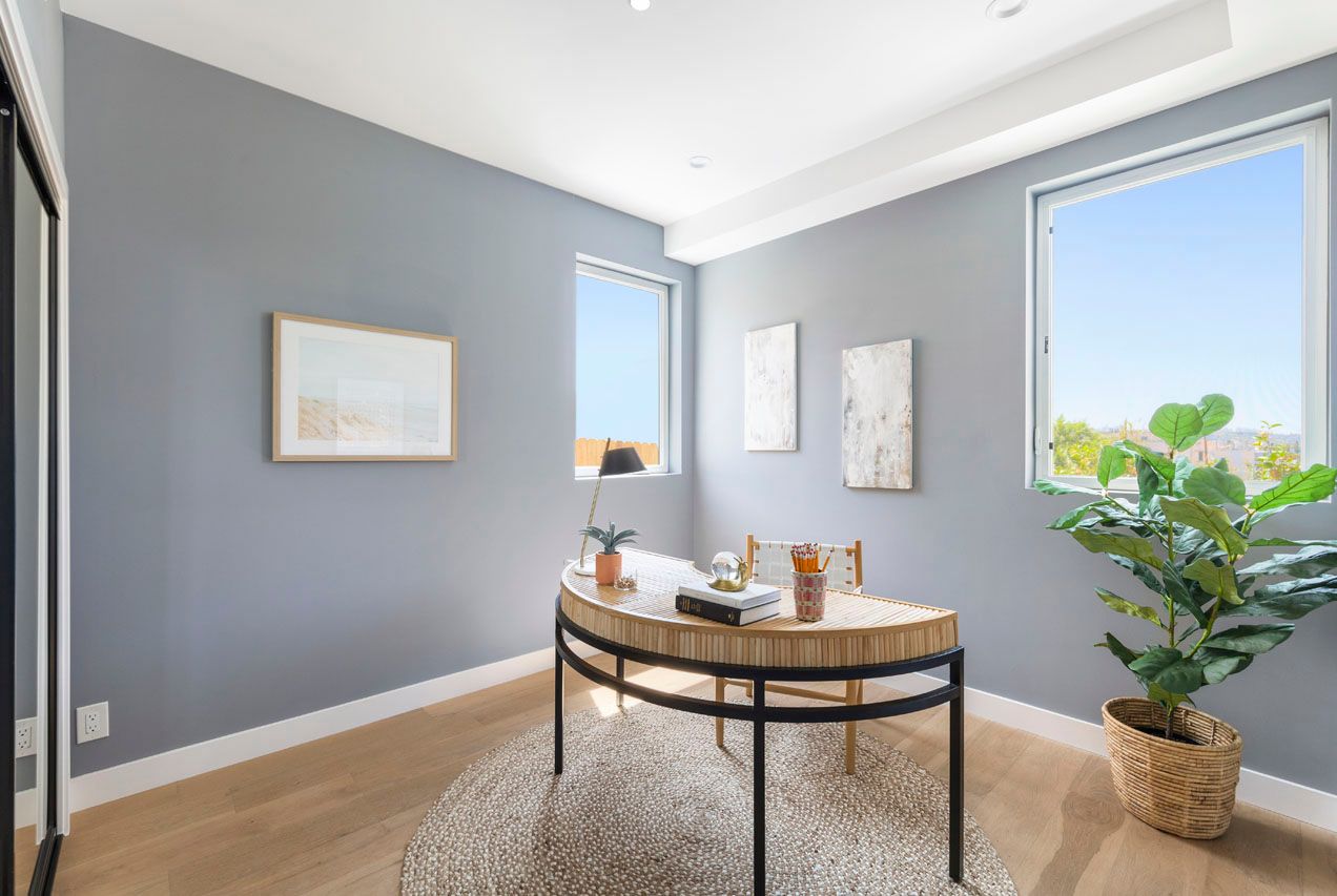 The sunny living area in an accessory dwelling unit (ADU) in-law unit, with sliding glass doors that open up to a backyard pool.