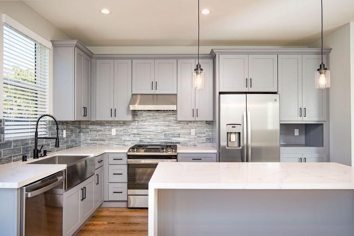 The full kitchen inside an accessory dwelling unit (ADU) backyard home in Los Angeles, CA, featuring plenty of space, an island, and modern all-electric appliances. 