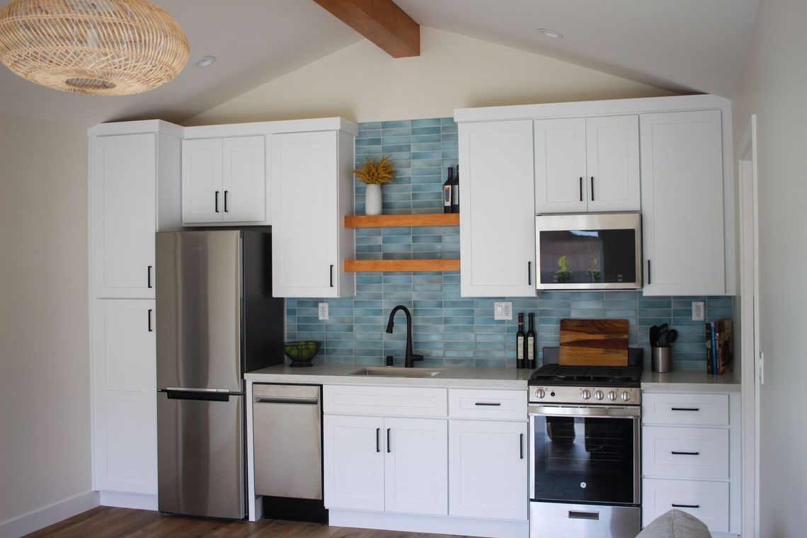 The full kitchen inside an accessory dwelling unit (ADU) backyard home, featuring modern all-electric appliances. 