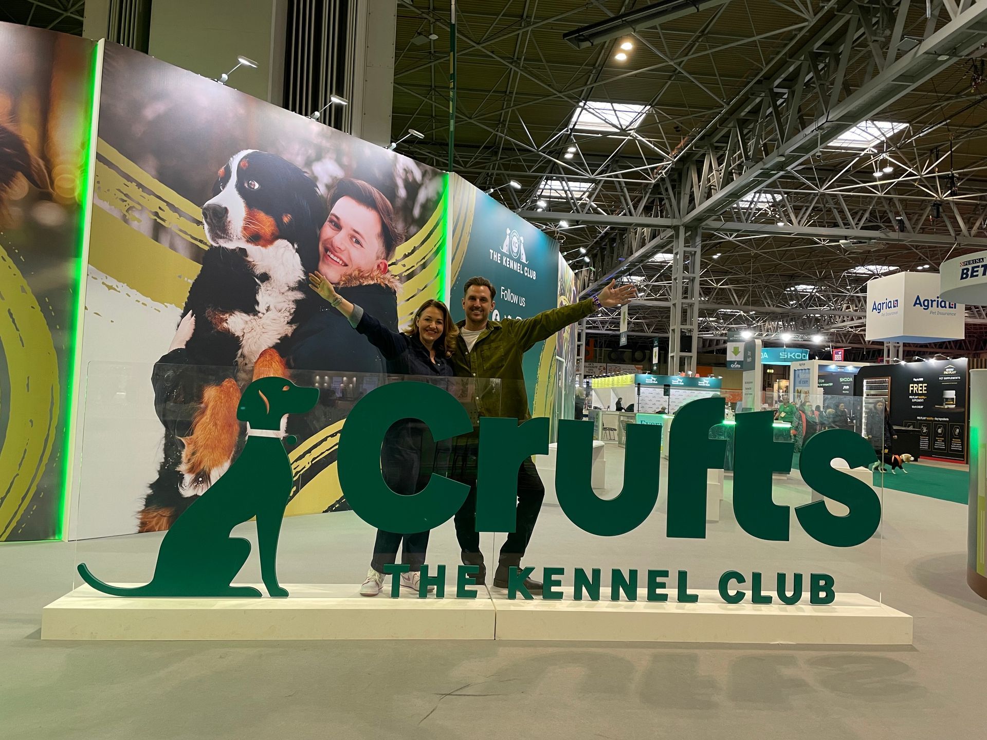 Crufts dog show display with a large dog and green logo at an exhibition hall
