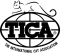 The logo for the international cat association with a cat on top of a globe.