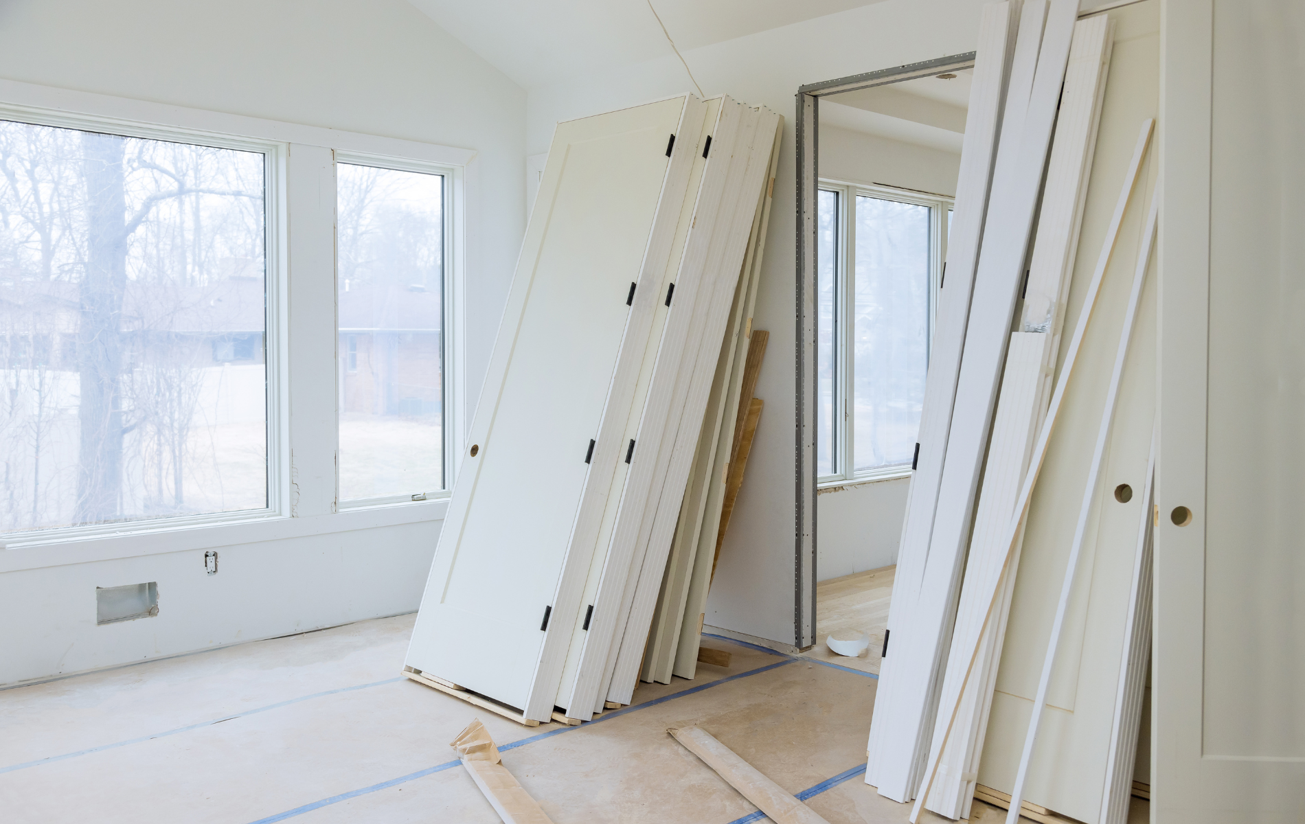 A room with a lot of doors stacked on top of each other.