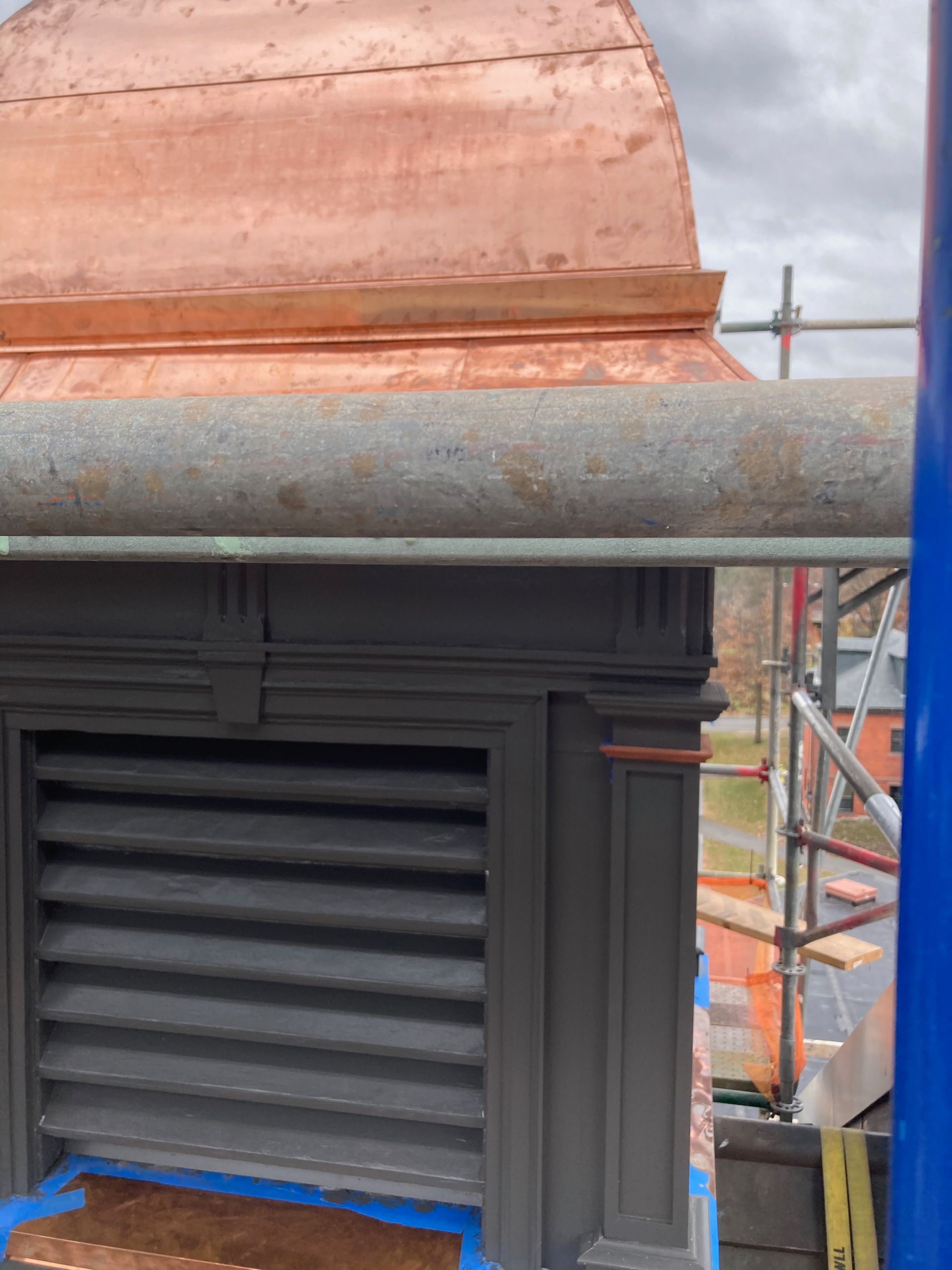 A copper roof is being installed on a building.