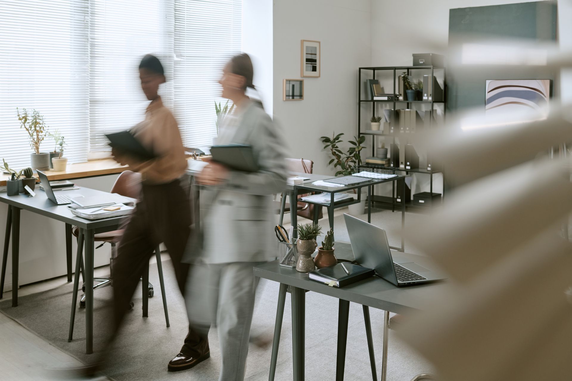 A smiling professional female or employer having a job interview meeting with a male candidate. Staffing agency recruiter meeting with a job candidate in an office.