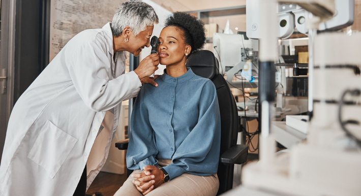 A woman is getting her eye checked.