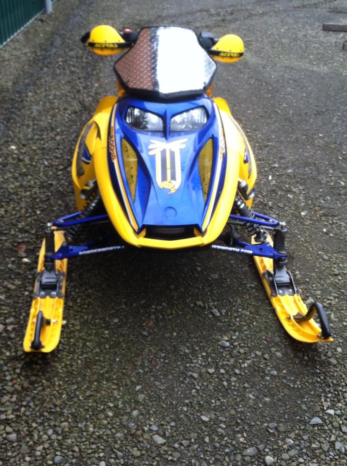 A blue and yellow snowmobile with the number 10 on the front