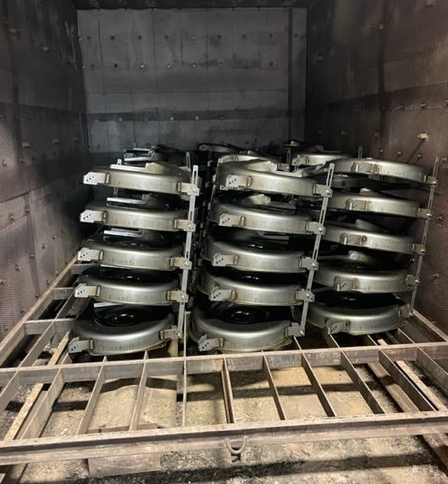 A bunch of metal parts are stacked on top of each other in a warehouse.