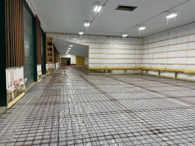 A large empty room with a concrete floor and walls.