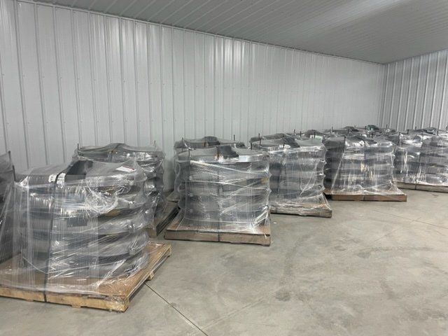 A warehouse filled with lots of wheels wrapped in plastic.