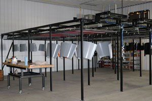 A large room with a lot of metal hanging from the ceiling.