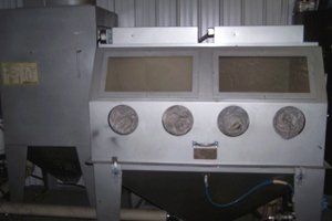 A machine that looks like a face is sitting in a room.