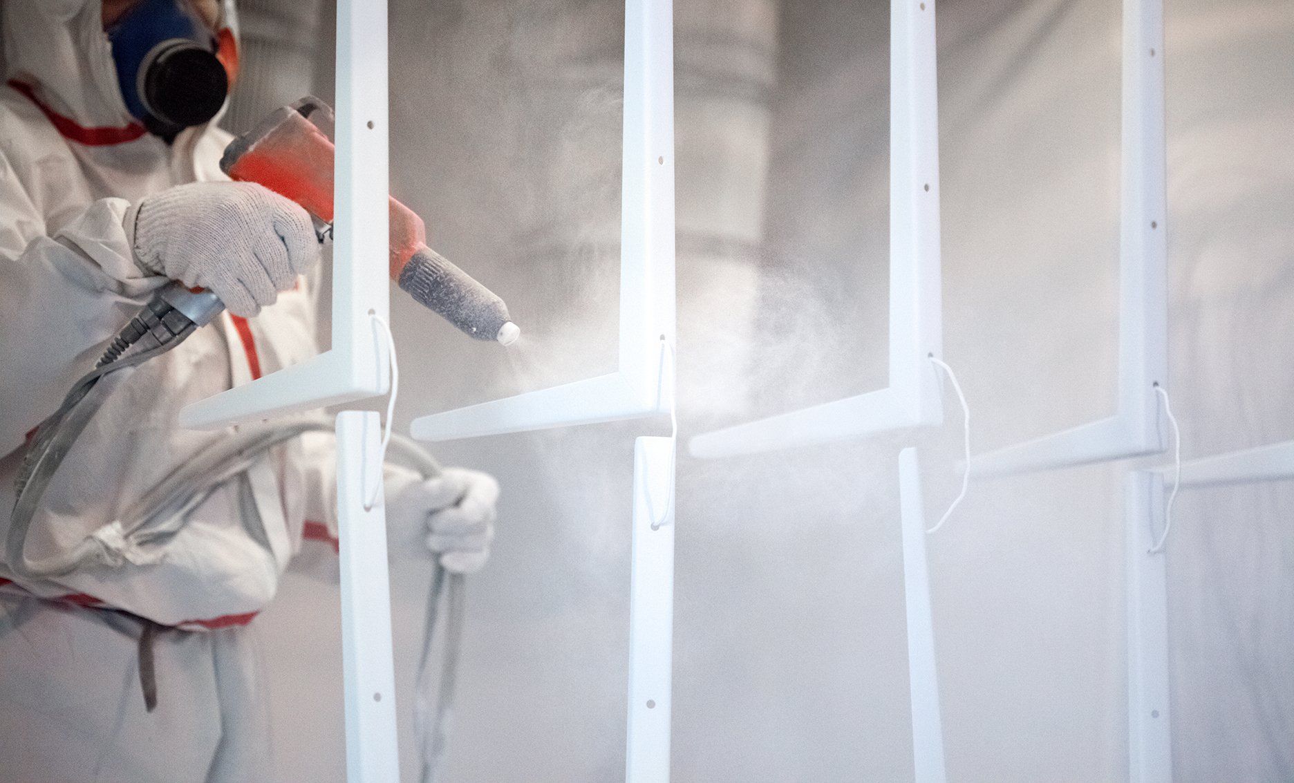 worker factory painting metal details gun