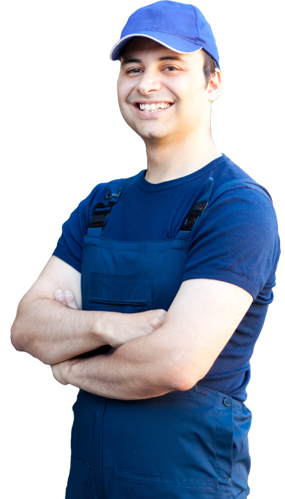 A man wearing overalls and a blue hat is smiling with his arms crossed.