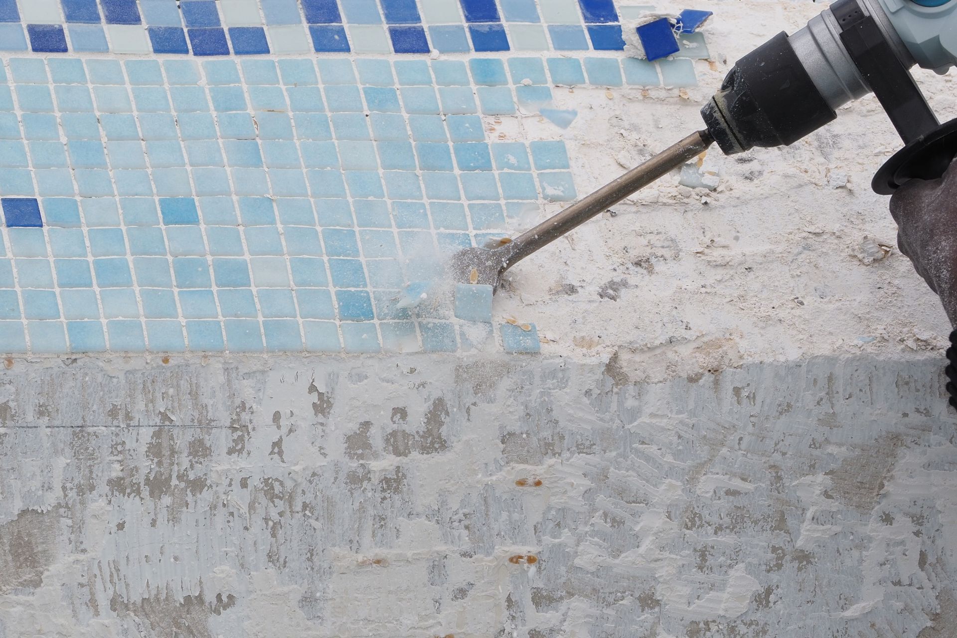 Pool remodeling with tile removal during swimming pool repair. Pool remodeling with tile removal during swimming pool repair.