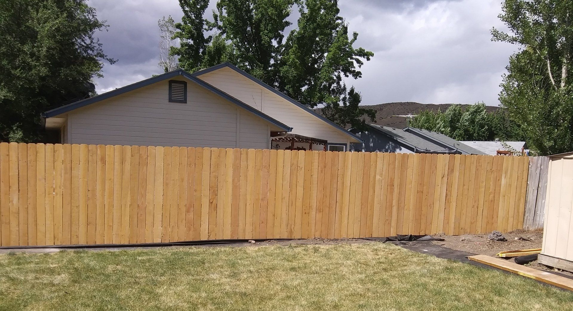 Newly built wooden privacy fence installed by A1 Handyman Garden City, ID providing backyard security and curb appeal