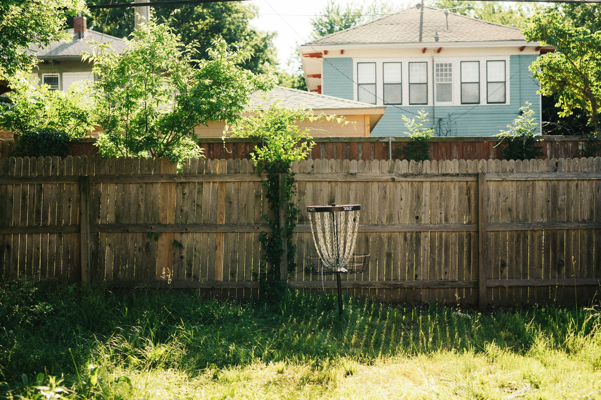 Weathered wood fence in a Boise backyard showing signs of wear over time