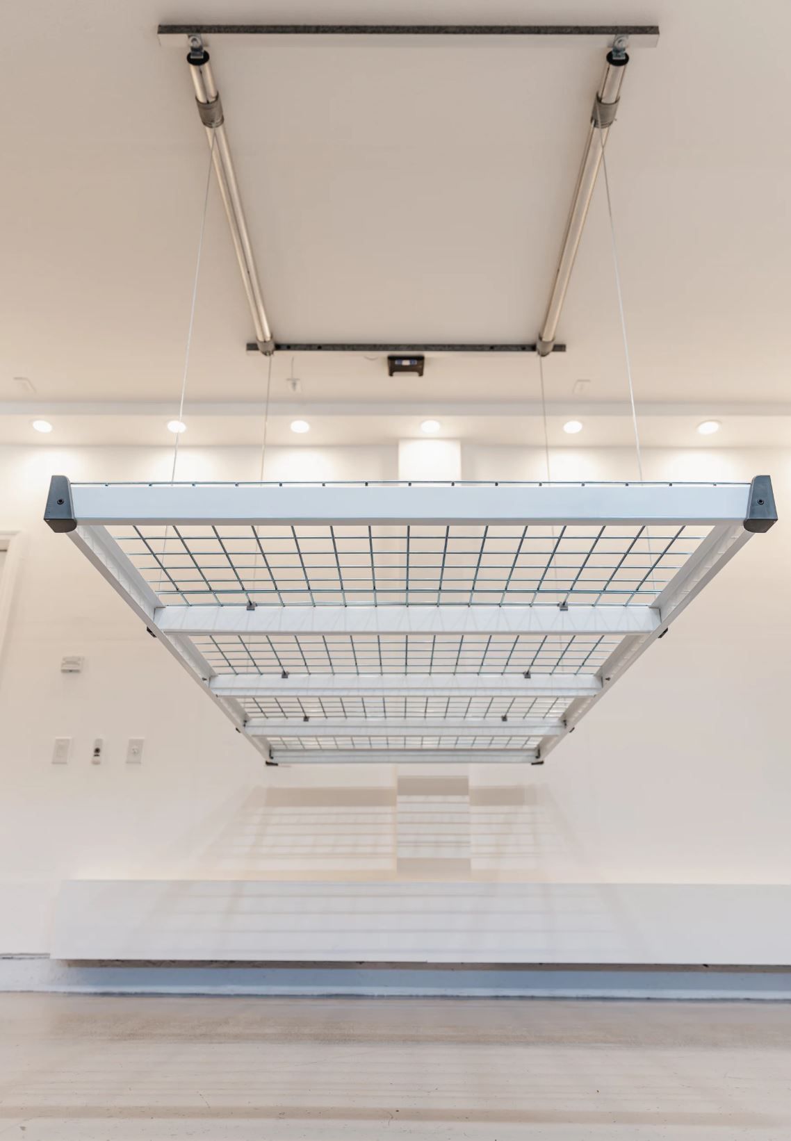 Motorized Auxx Lift overhead garage storage rack installed for ceiling storage in a Boise, Idaho home