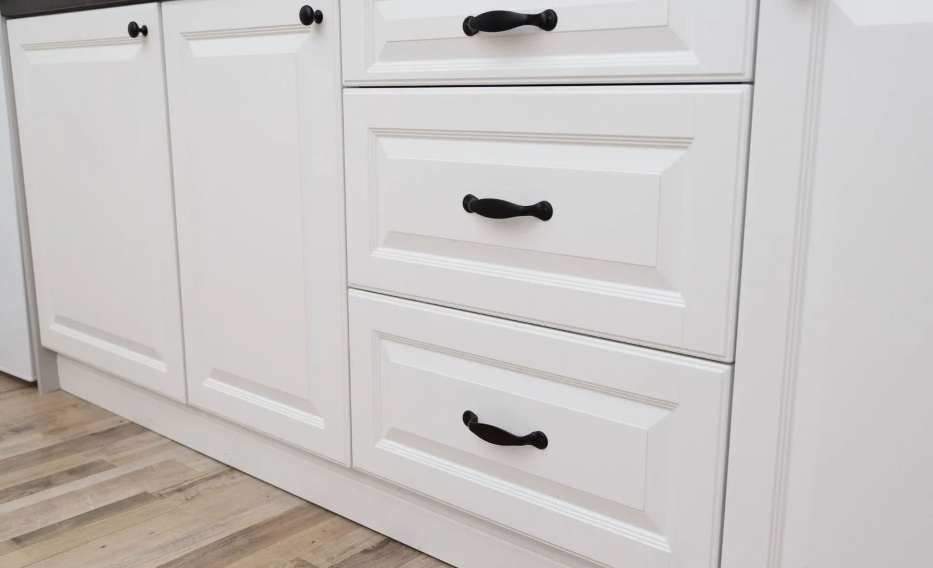 Cabinet door and drawer repair in a Boise, ID kitchen with aligned doors and replaced hardware