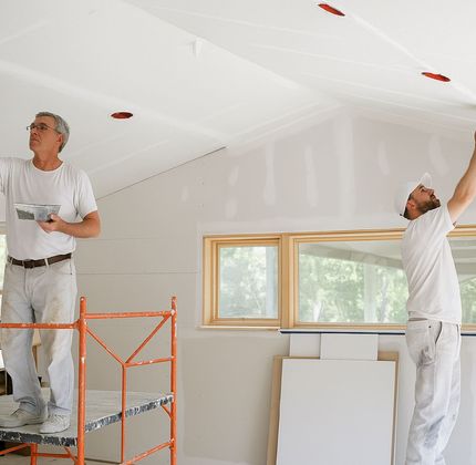 A1 Handyman technicians finishing drywall on a vaulted ceiling in a bright Boise, ID home
