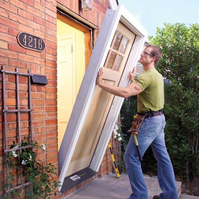 A1 Handyman technician installing a front entry door in Garden City, ID