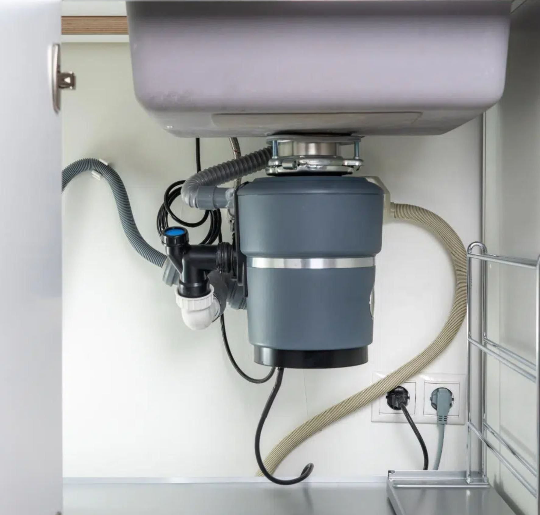 Garbage disposal installed under a kitchen sink in a Boise, Idaho home