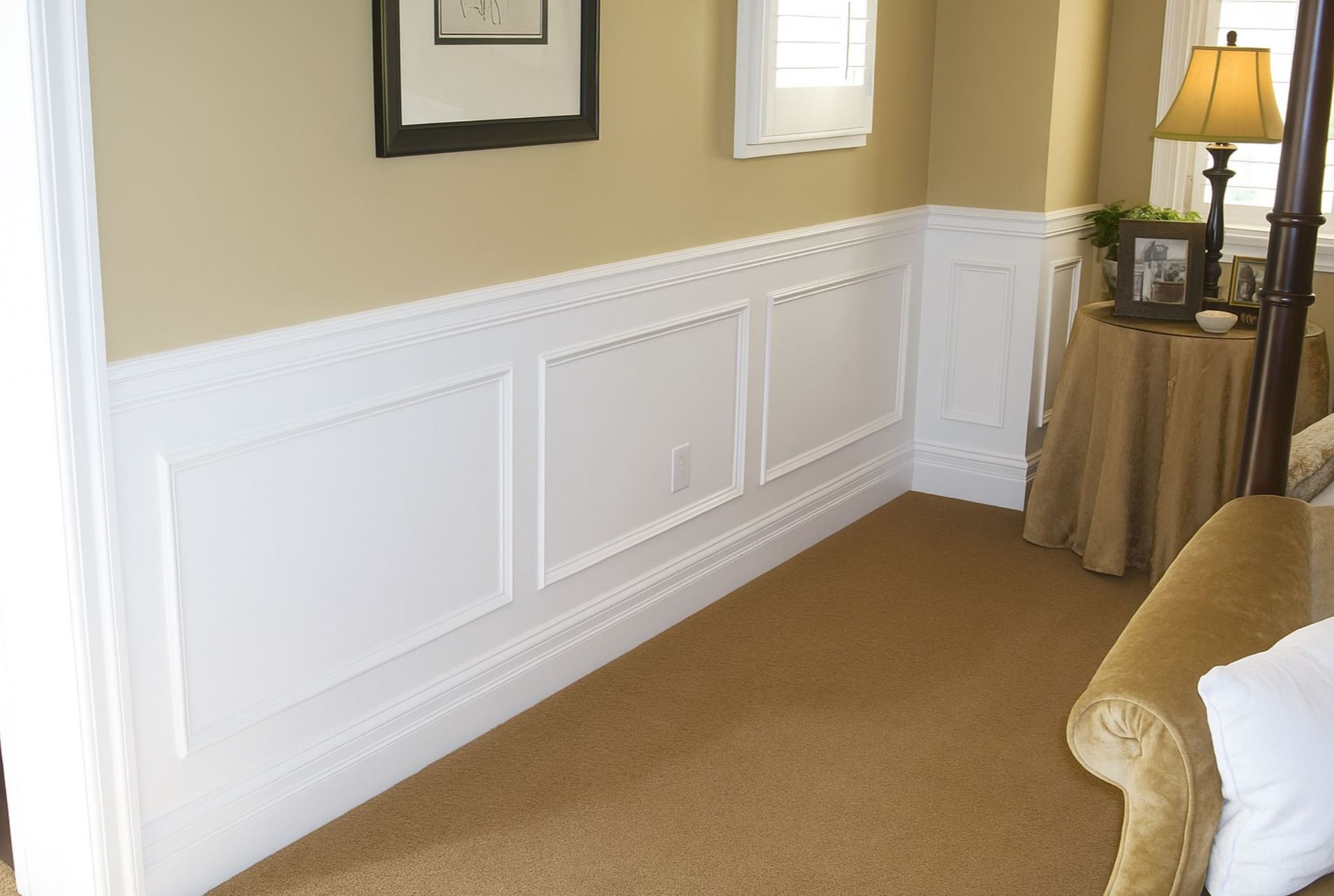 Raised panel wainscoting installation with baseboard trim in a finished living space