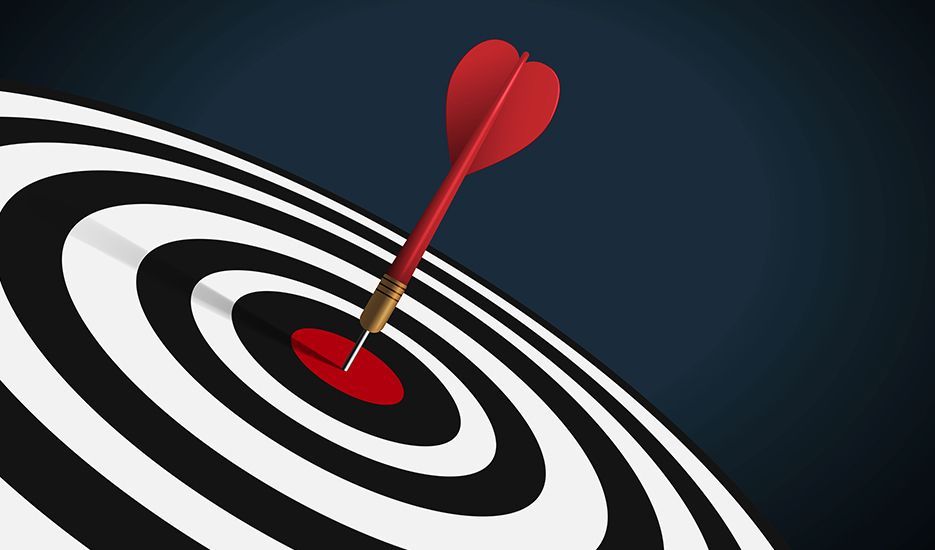 A red dart is in the center of a black and white target.