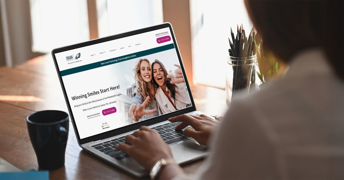 Websites for dentists displayed on a modern dental practice website viewed on a laptop by a patient searching for dental care online.