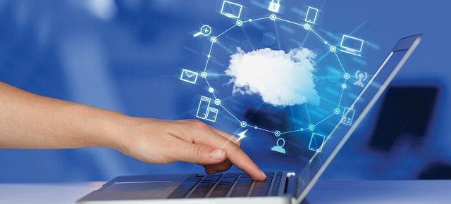 A person is using a laptop computer with a cloud coming out of the screen.